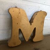 Golden sign letter "M"