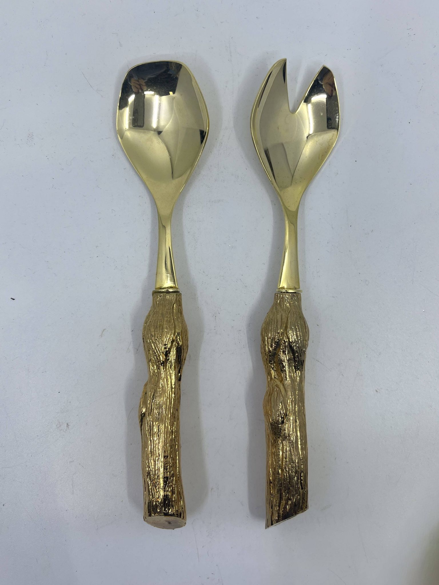 Lot of serving spoons, dessert spoon and fork in gold metal.