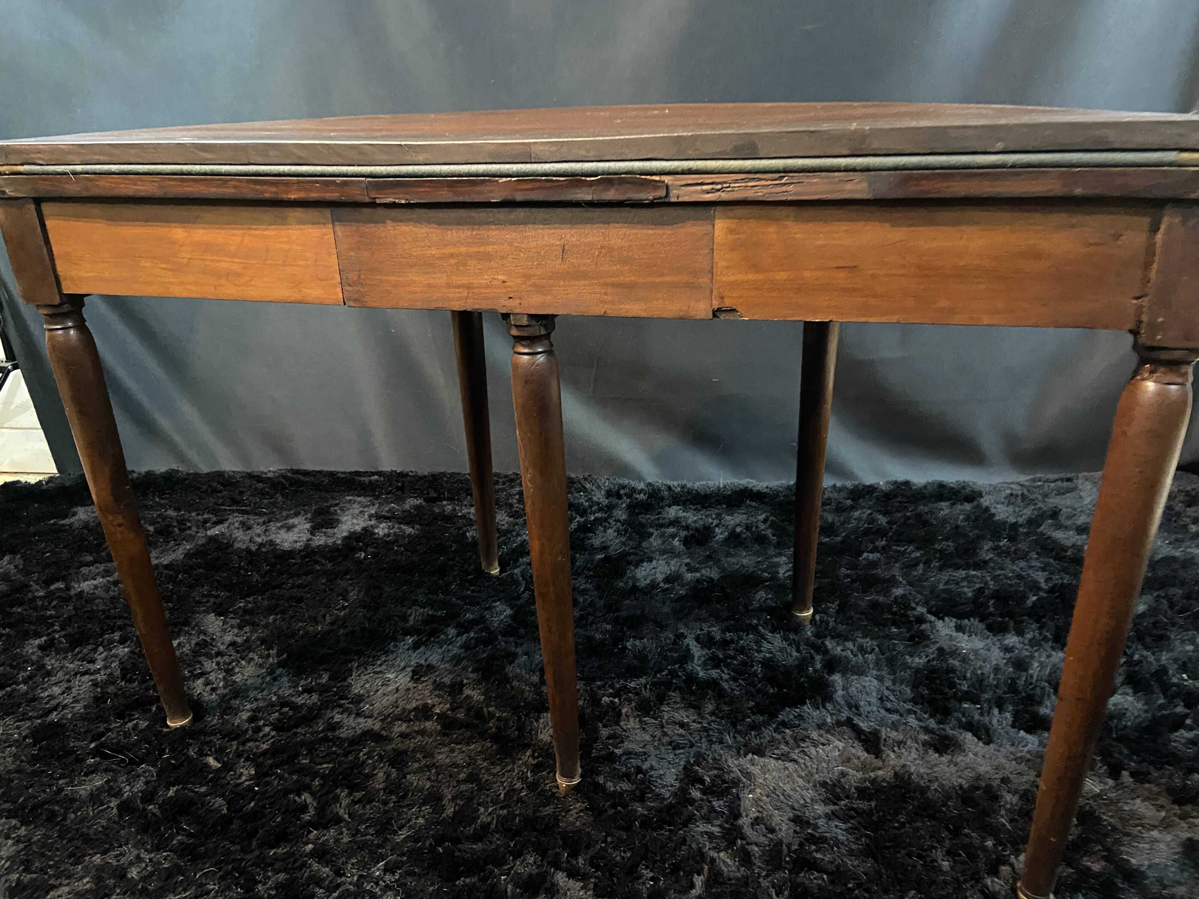 A Louis XVI period mahogany half-moon table forming a console/games table