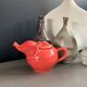 Large coral-coloured elephant teapot.