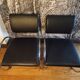 Pair of chrome and faux leather armchairs