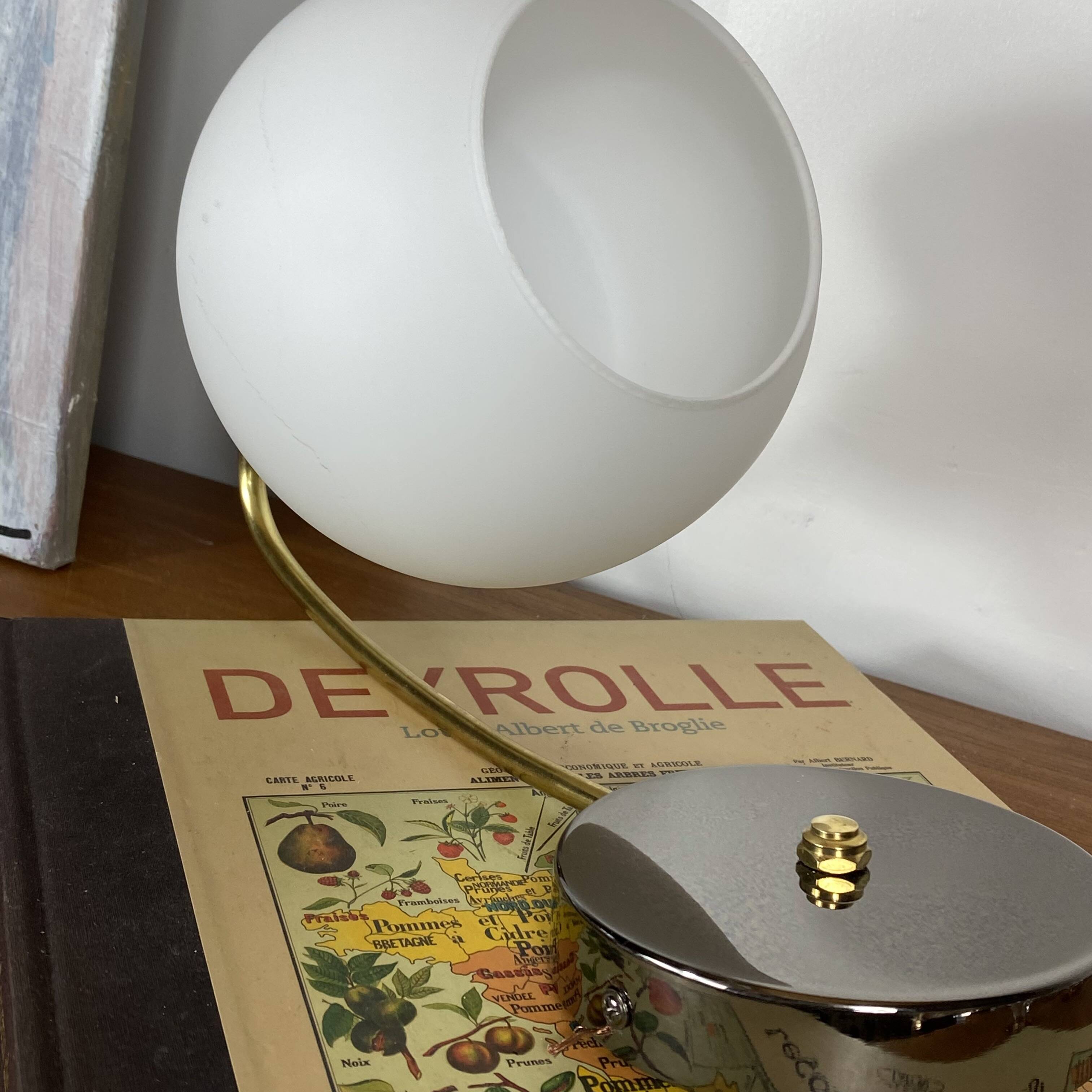 Antique swan neck wall light in brass with a white opaline tulip shade.
