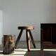 Small low armchair in varnished brown wood