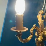 Louis XV bronze wall light with a flowing branch design and acanthus leaf decoration.