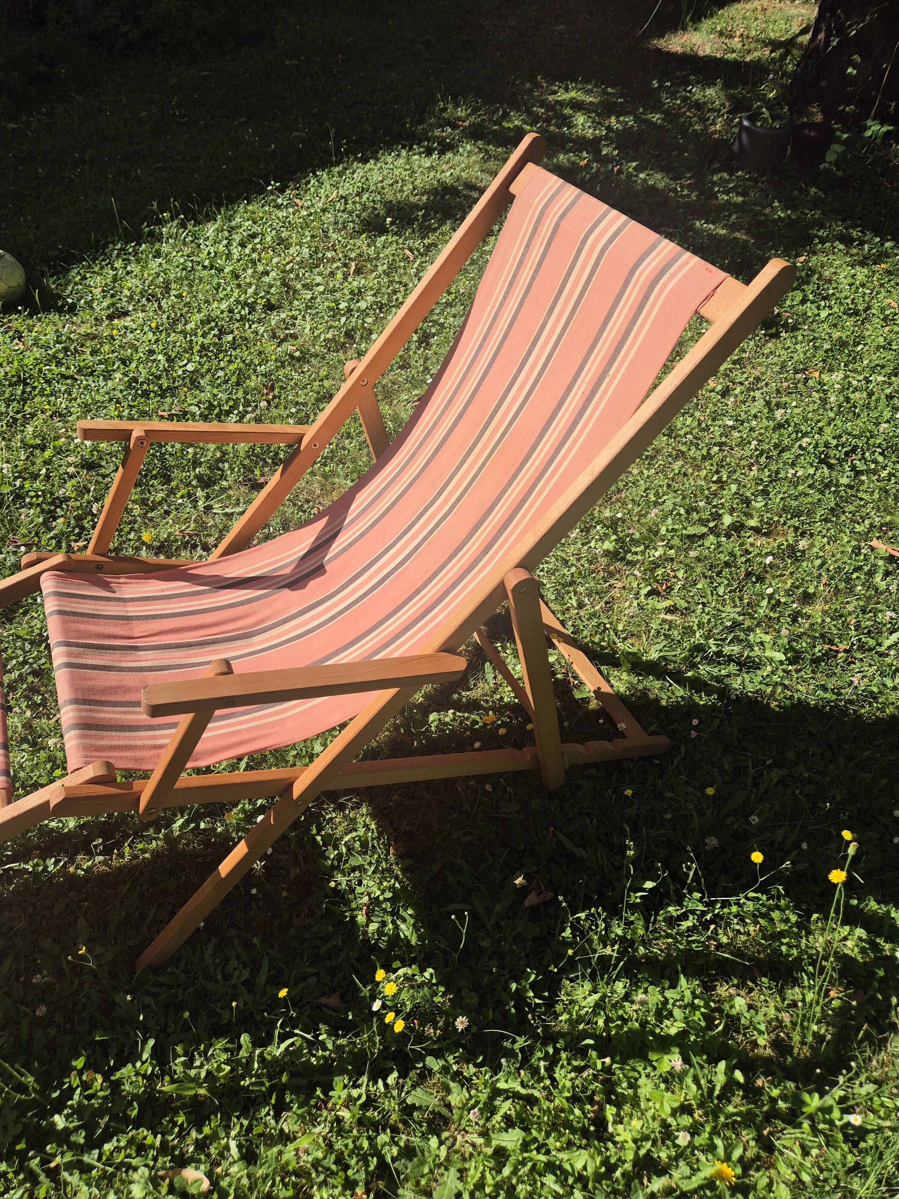 vintage wooden deck chair with striped fabric and footrest