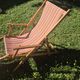 vintage wooden deck chair with striped fabric and footrest