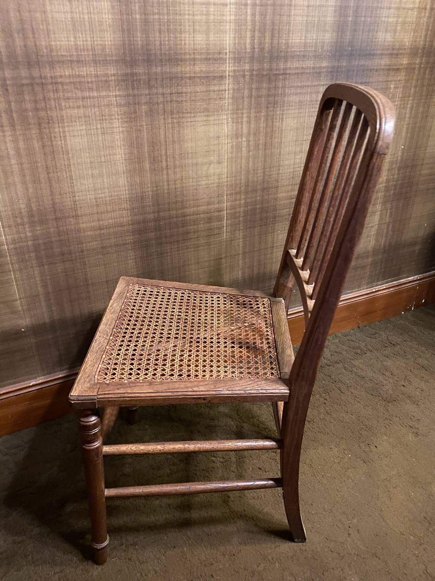 Set of 2 antique wooden chairs with caned seats.