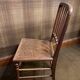 Set of 2 antique wooden chairs with caned seats.