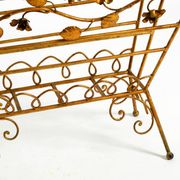 Extraordinary mid-century newspaper and magazine rack with a gilded metal