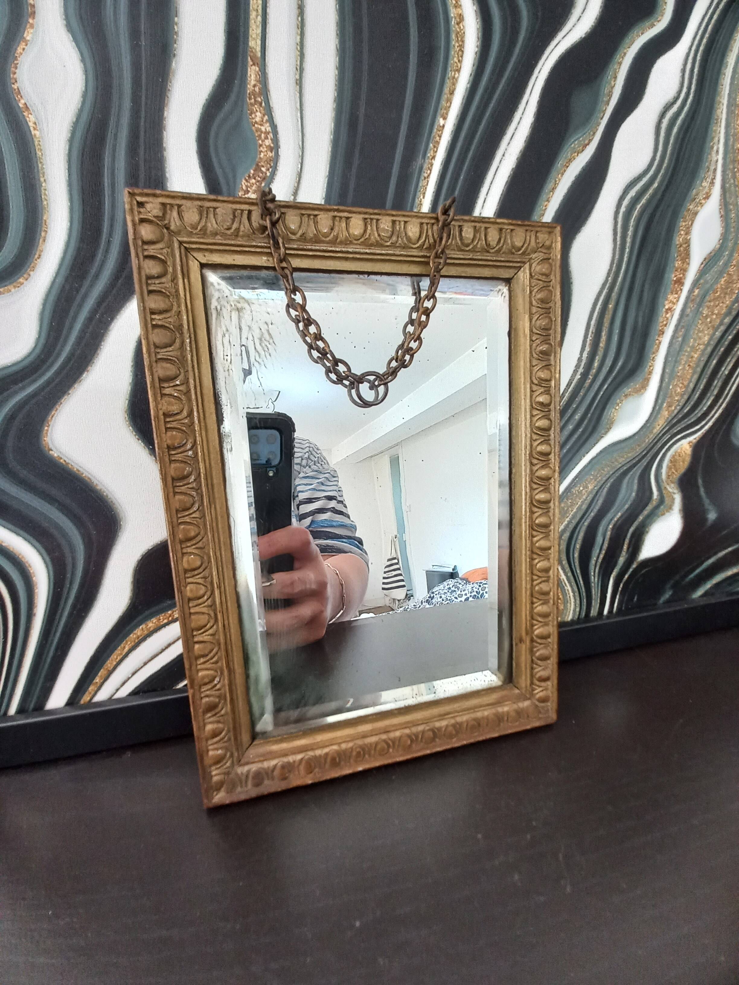 Small vintage mirror in gilded wood, bevelled glass with chain.