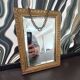 Small vintage mirror in gilded wood, bevelled glass with chain.
