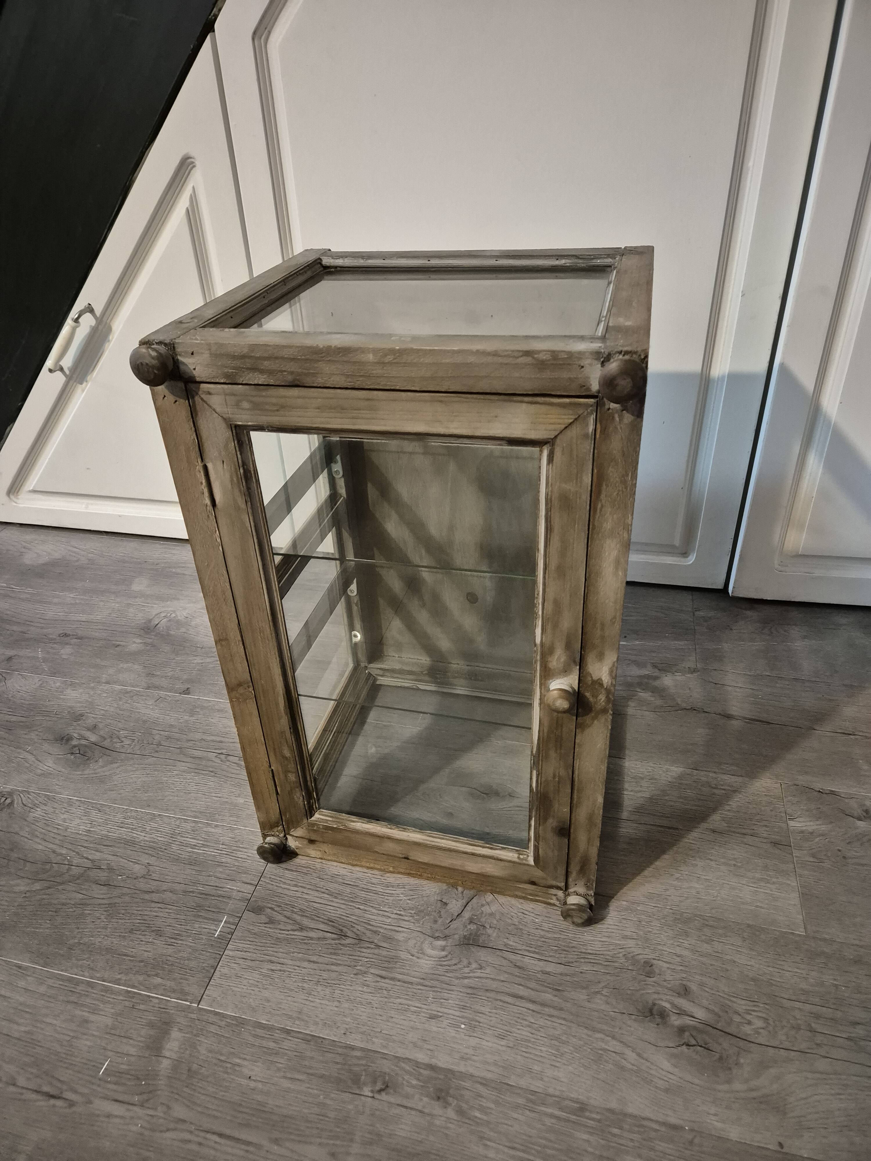 Brown weathered wooden display cabinet with 2 glass shelves.