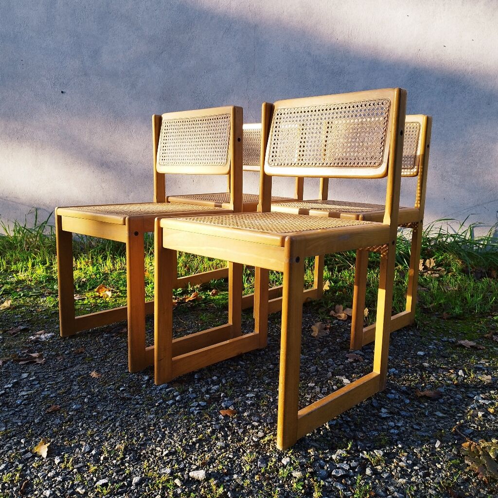 Four trendy tanned wooden chairs