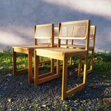 Four trendy tanned wooden chairs