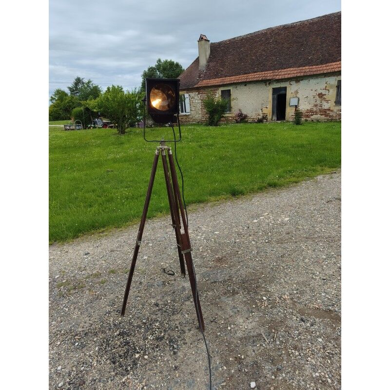 Spotlight on wooden and chrome tripod.