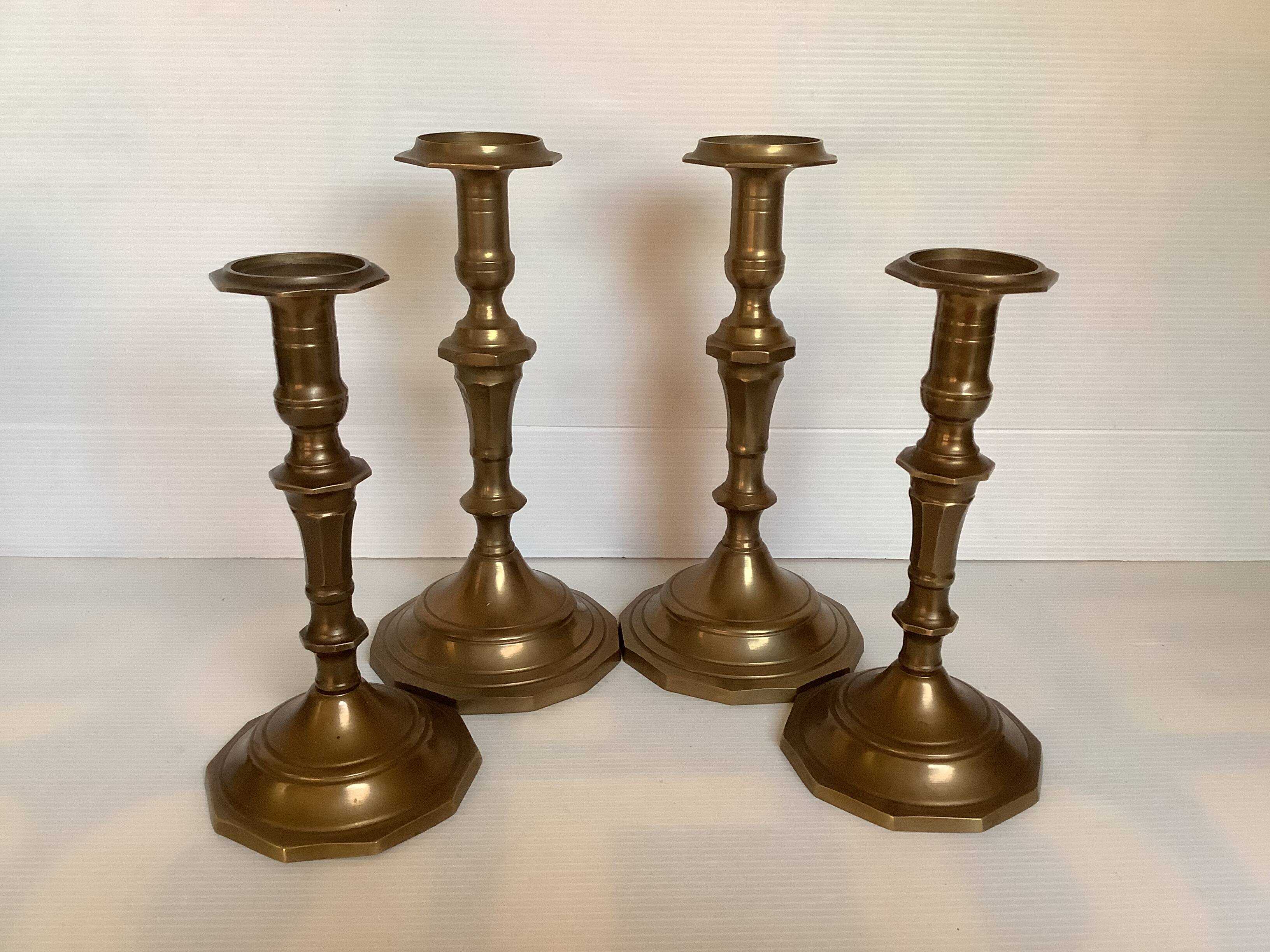Four brass candle holders