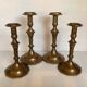Four brass candle holders