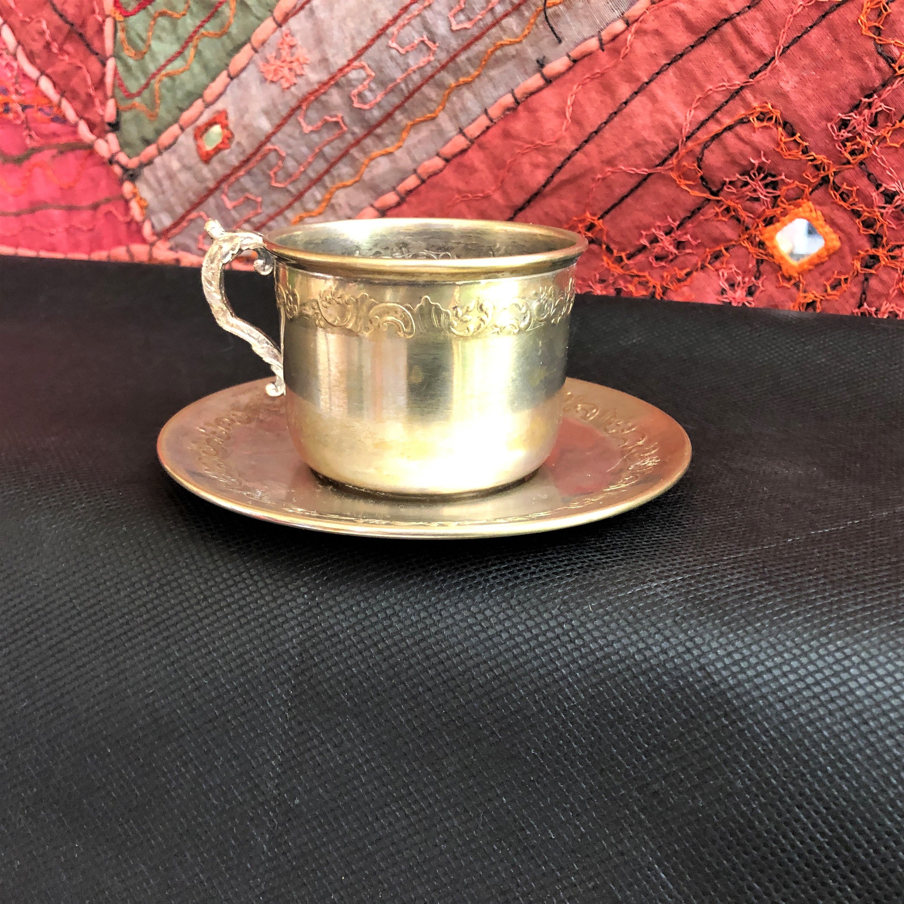 Silver metal cup and saucer