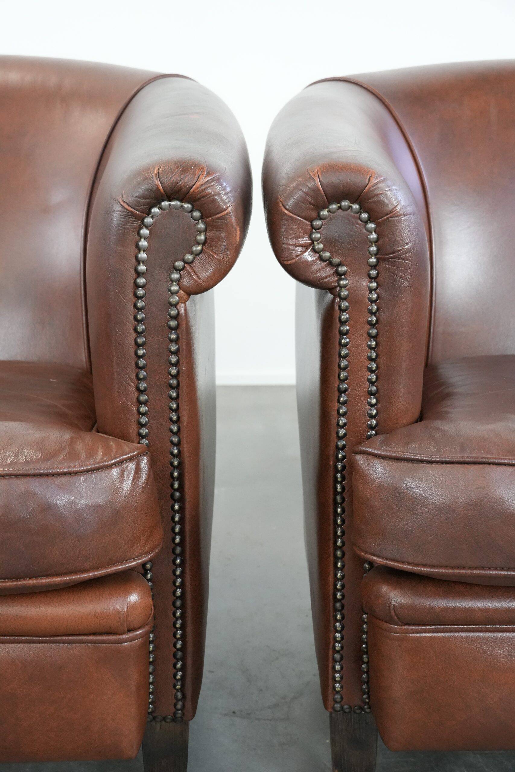 Unique set of two cognac-coloured cow leather club armchairs
