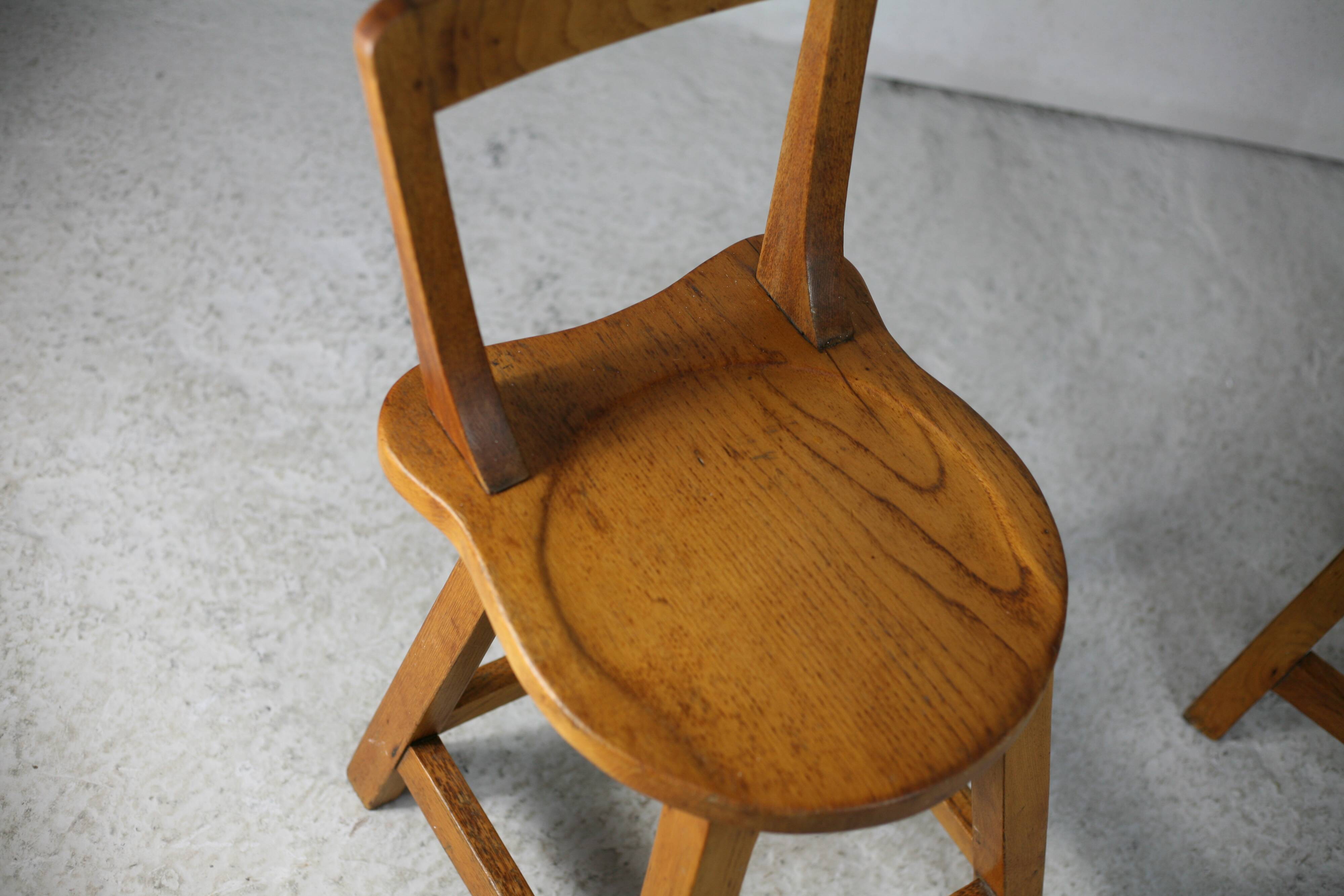Pair of brutalist wooden back stools. France, circa 1960