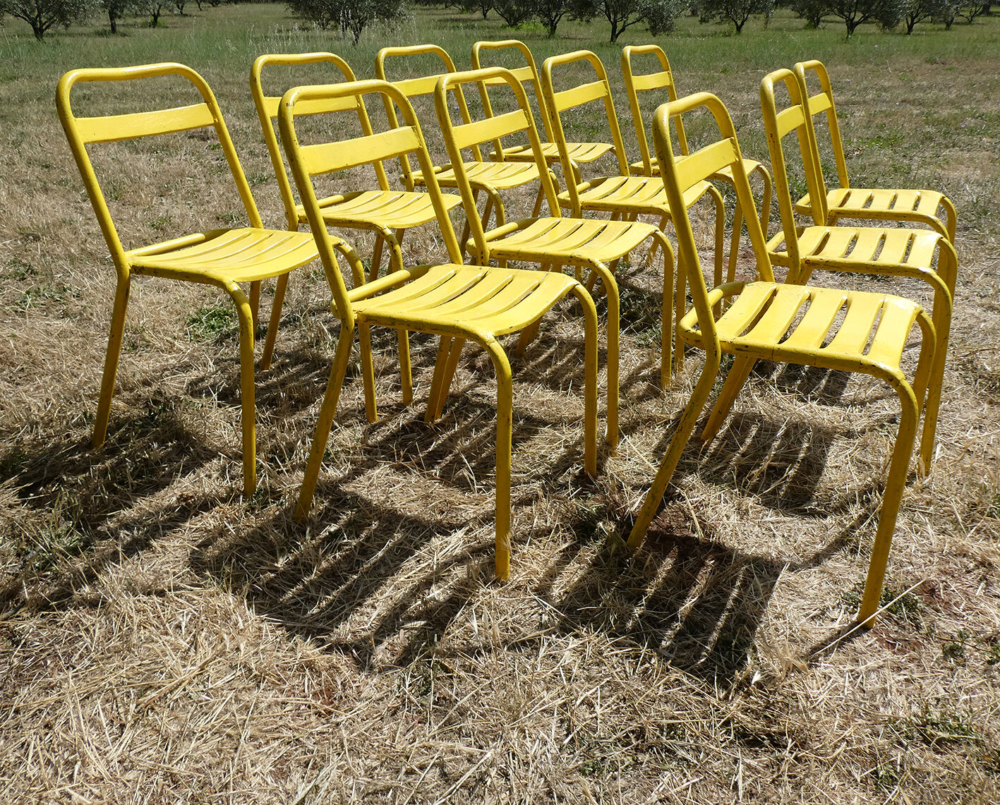 Lot of 11 yellow metallic bistro chairs from the 1950s
