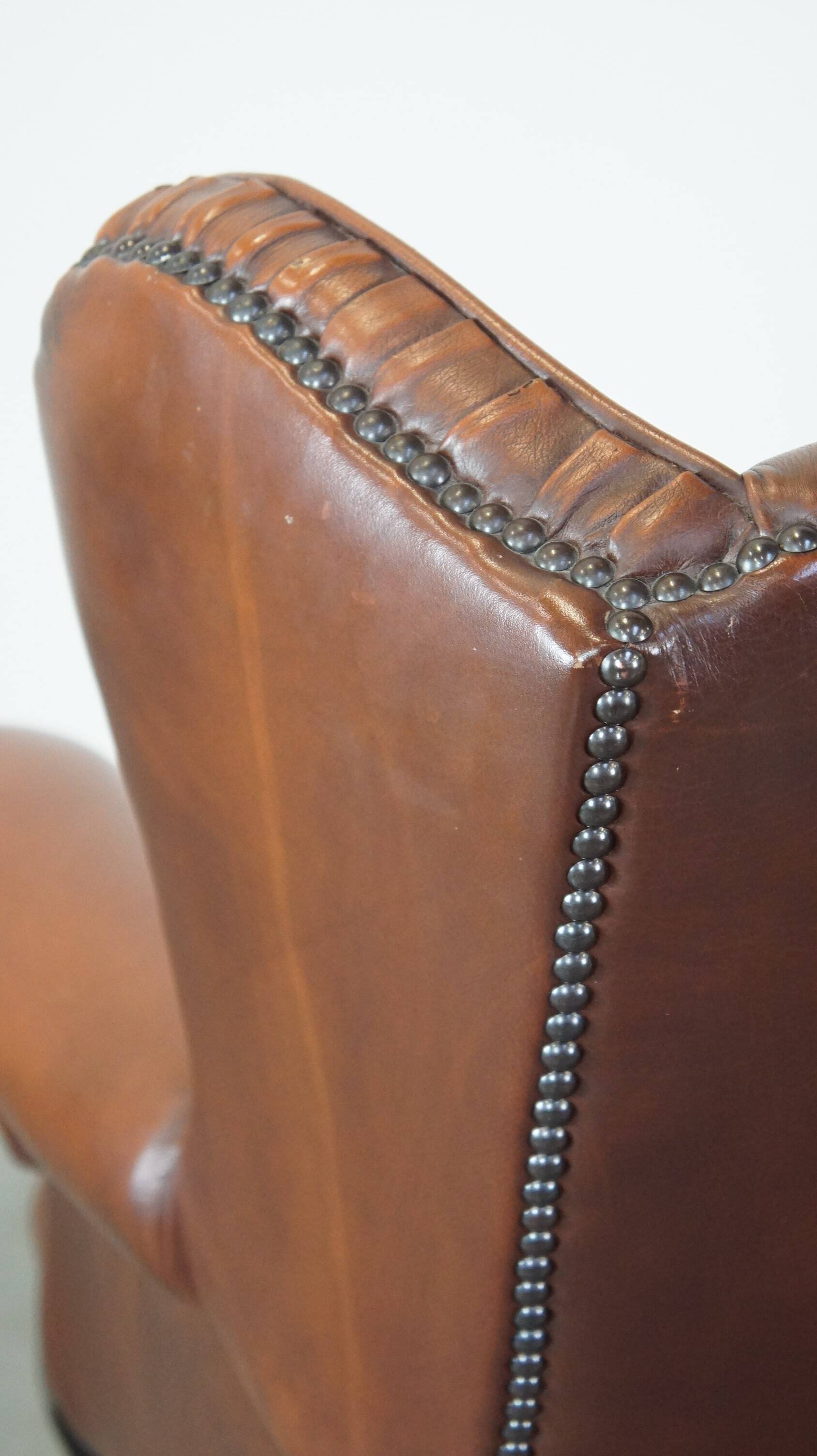 Brown leather wingback Chesterfield armchair