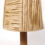 Lamp base in saddle stitched leather and raffia lampshade.