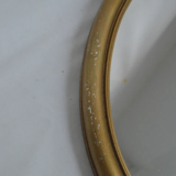 Oval mirror in gilded wood