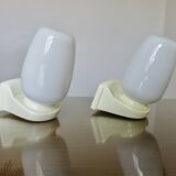 Pair of "streamline" opaline wall lights, France, 1970s-1980s.