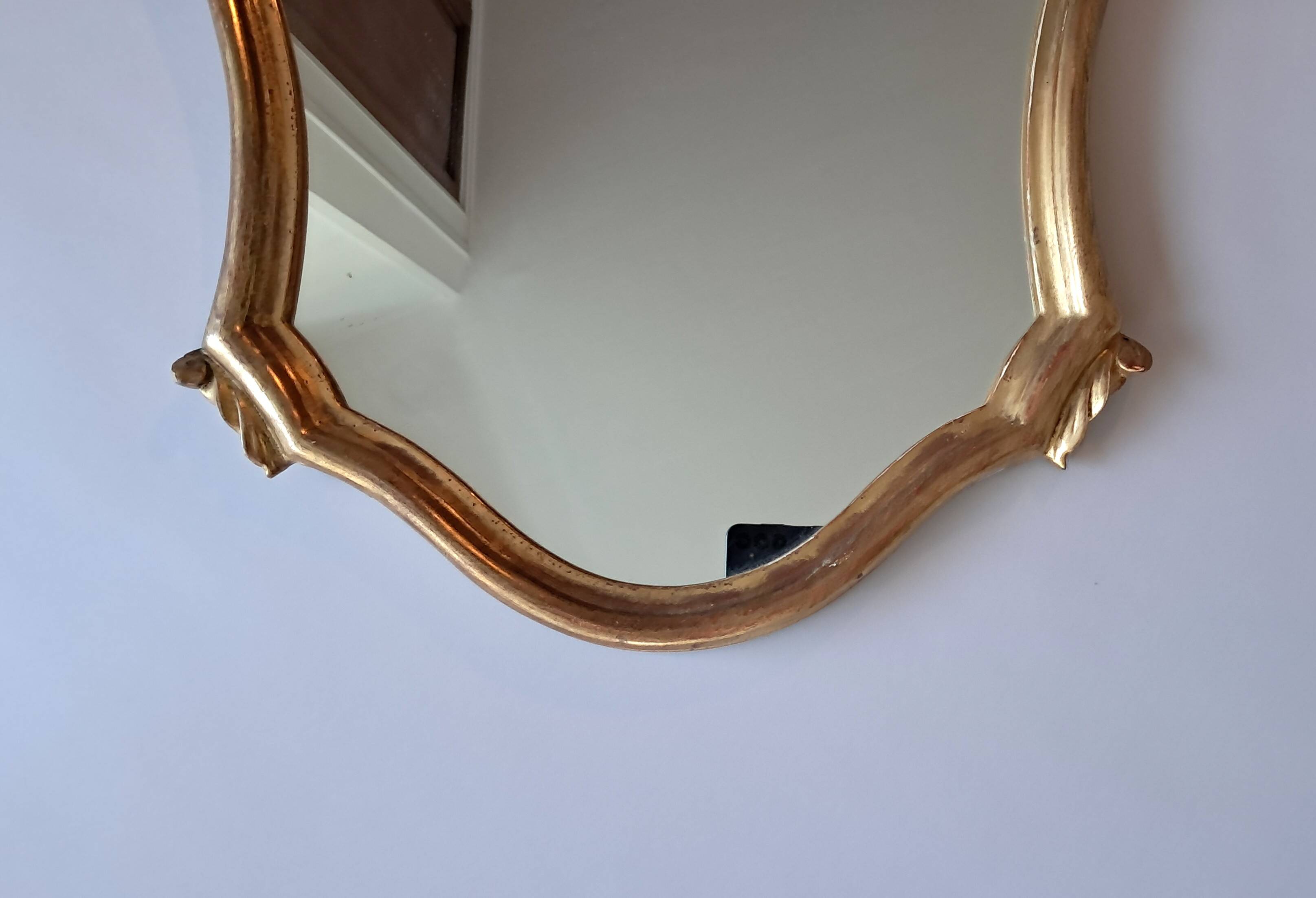 1950s rococo mirror in gilded stucco.