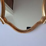 1950s rococo mirror in gilded stucco.