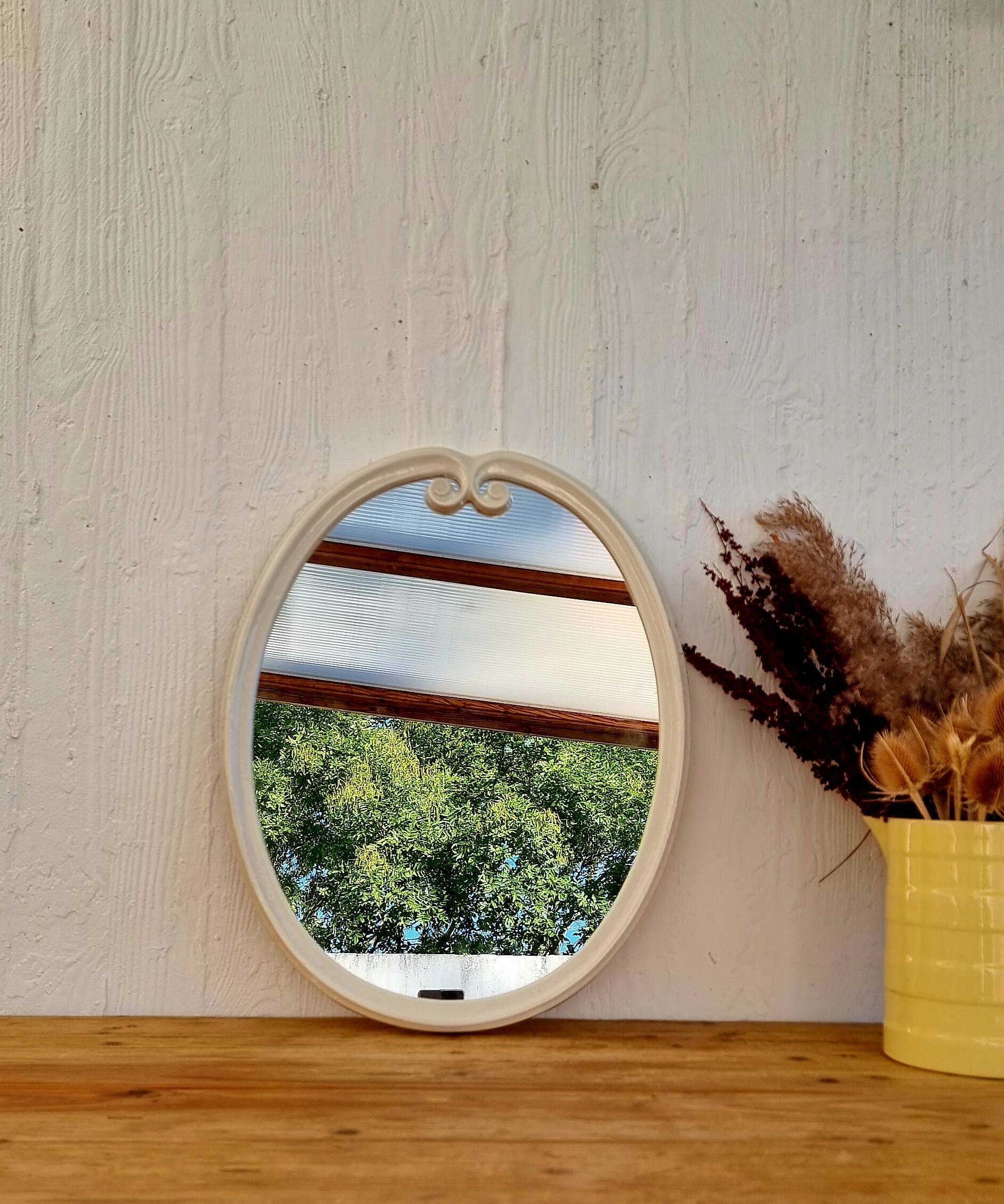 Vintage enamelled metal oval mirror