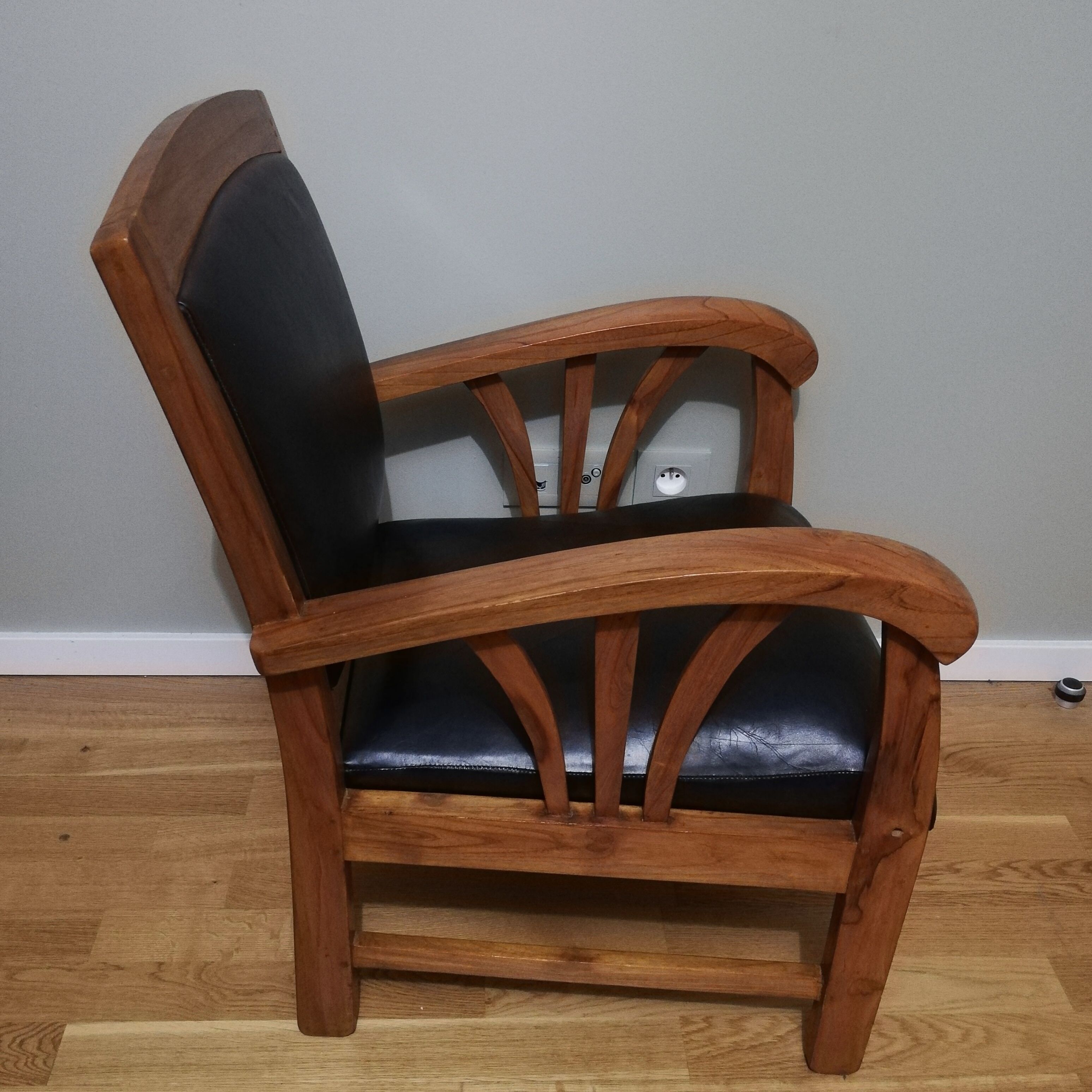 Colonial armchair in teak and black leather
