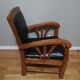 Fauteuil colonial en teck et cuir noir