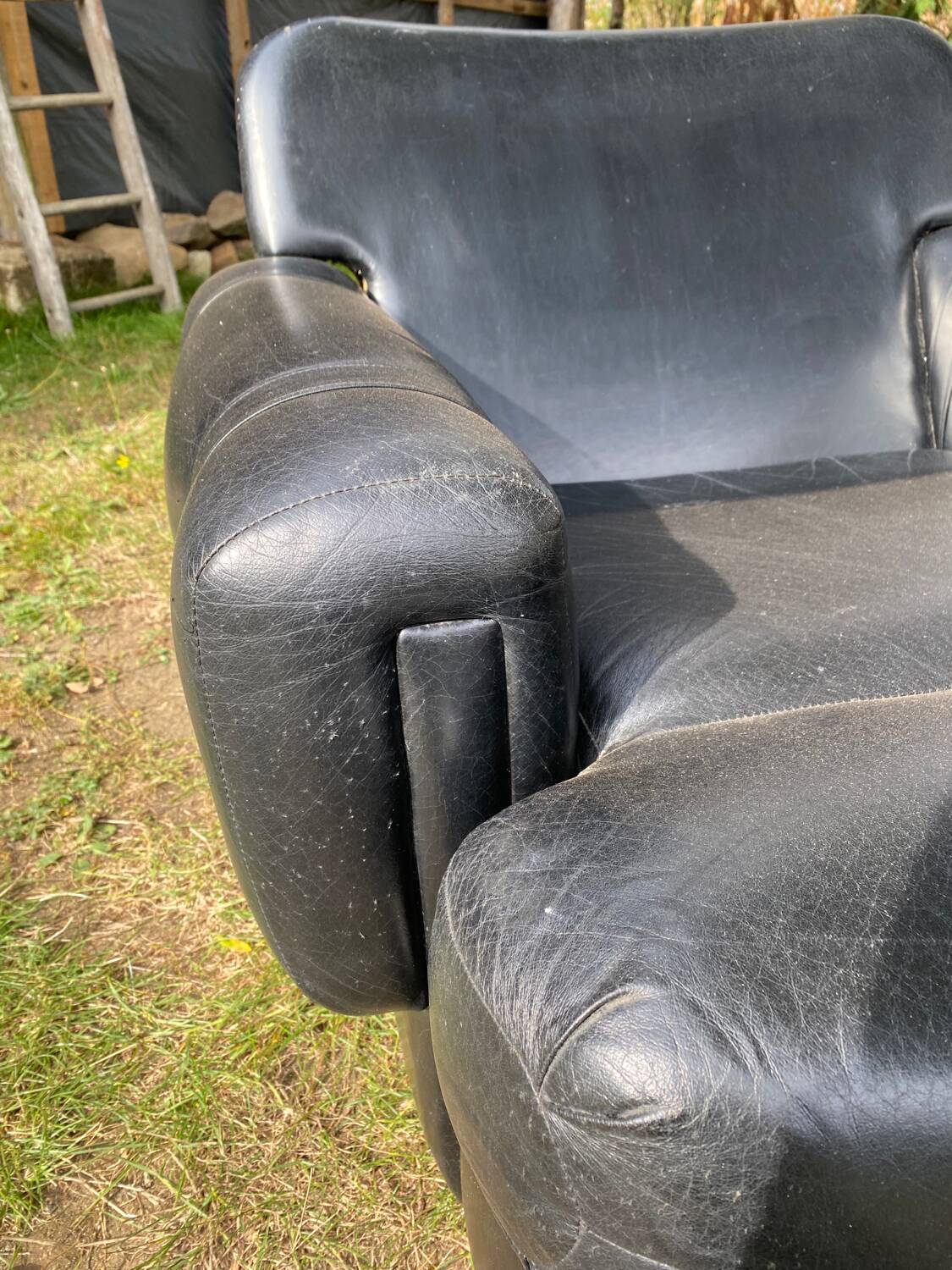 Pair of black imitation leather armchairs
