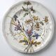 Antique Longchamp shallow dish with polychrome daisies in ironstone.