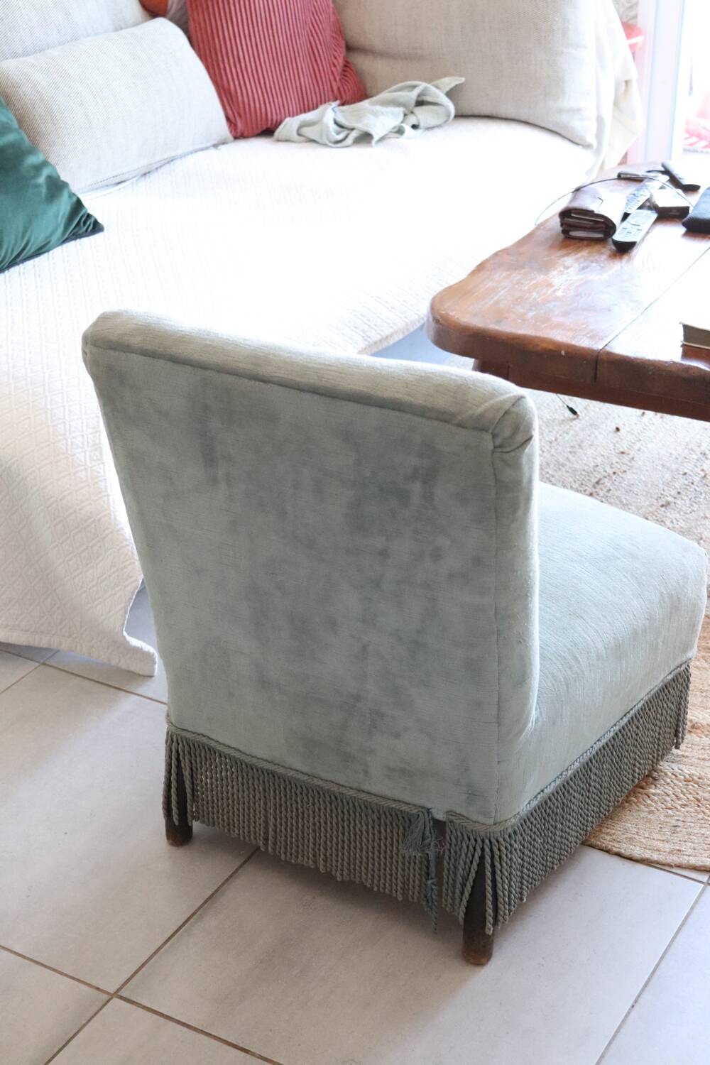Vintage blue velvet fringed armchair.