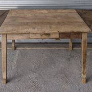 Old farmhouse table with its 2 extensions and raised legs.