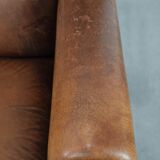 Large and comfortable sheepskin leather wingback chair with black piping