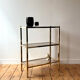 Brass and smoked glass library shelves