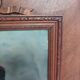 Antique wooden frame with carved portrait knot