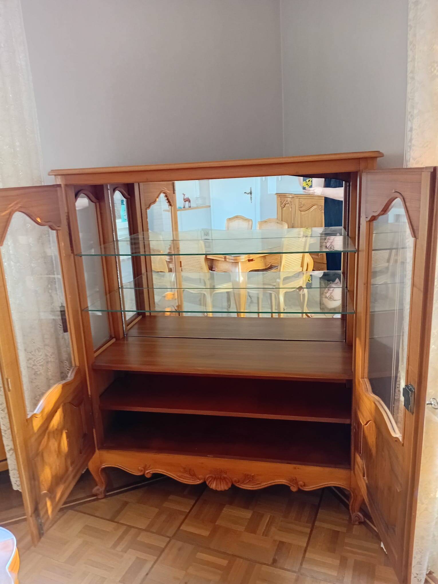 Showcase with shell mouldings in wood, glass, and mirror.
