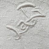 Set of 6 white damask hemmed napkins with handmade stitching and monogram.