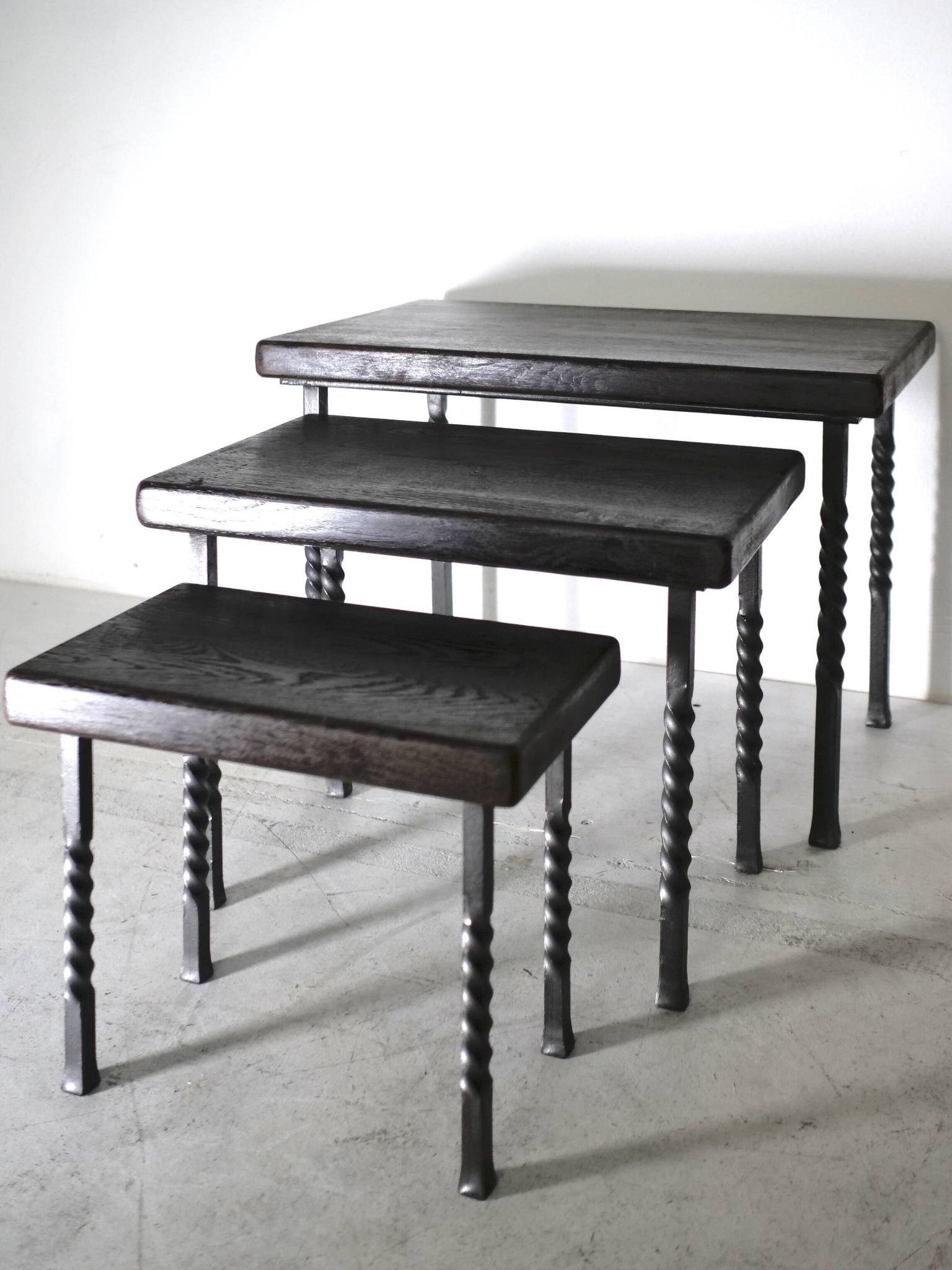 Brutalist nesting table in ebonized oak and wrought iron