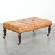 Sheepskin ottoman/coffee table on wheels in English chesterfield style