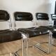 Set consisting of a table in chrome and smoked glass and its 4 tubular chairs in chrome and skaï a