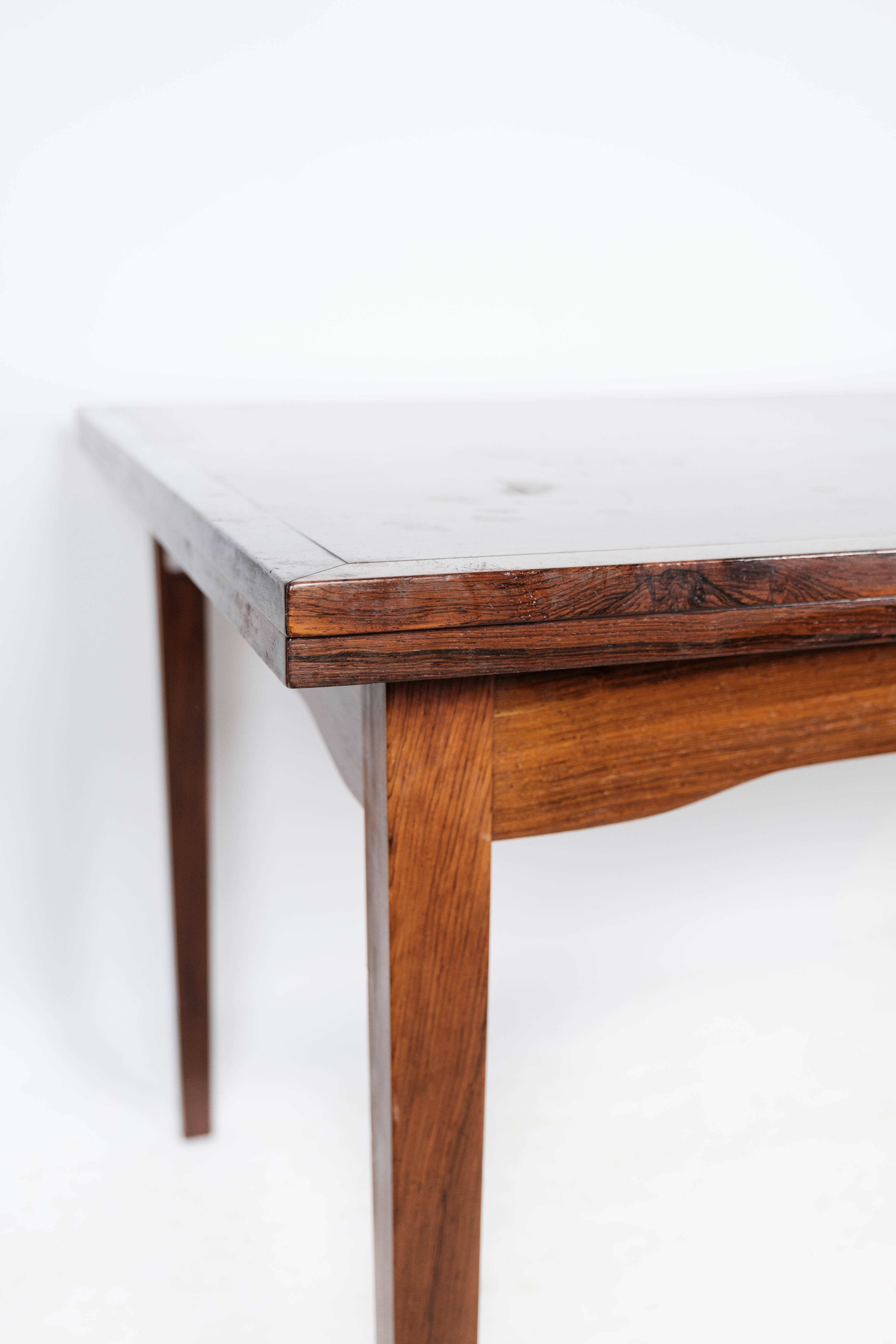 Dining table in rosewood with extension, of Danish design by Ellegaards Furniture, 1960s