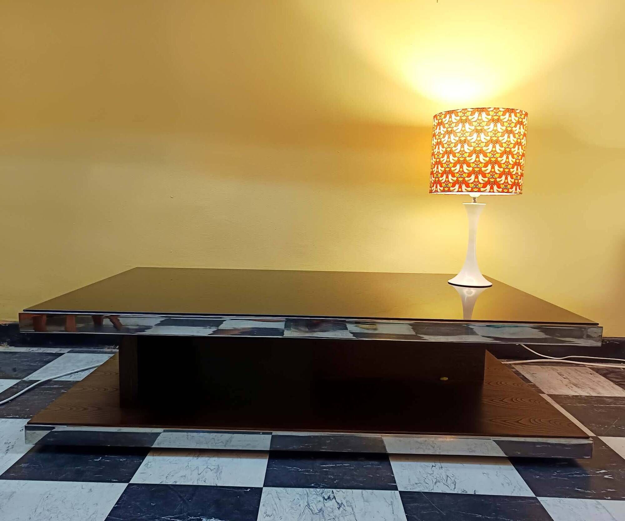 Designer coffee table in glass and chrome metal.