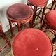 Series of 9 bistro bar stools in curved wooden restaurant sitting red fabric