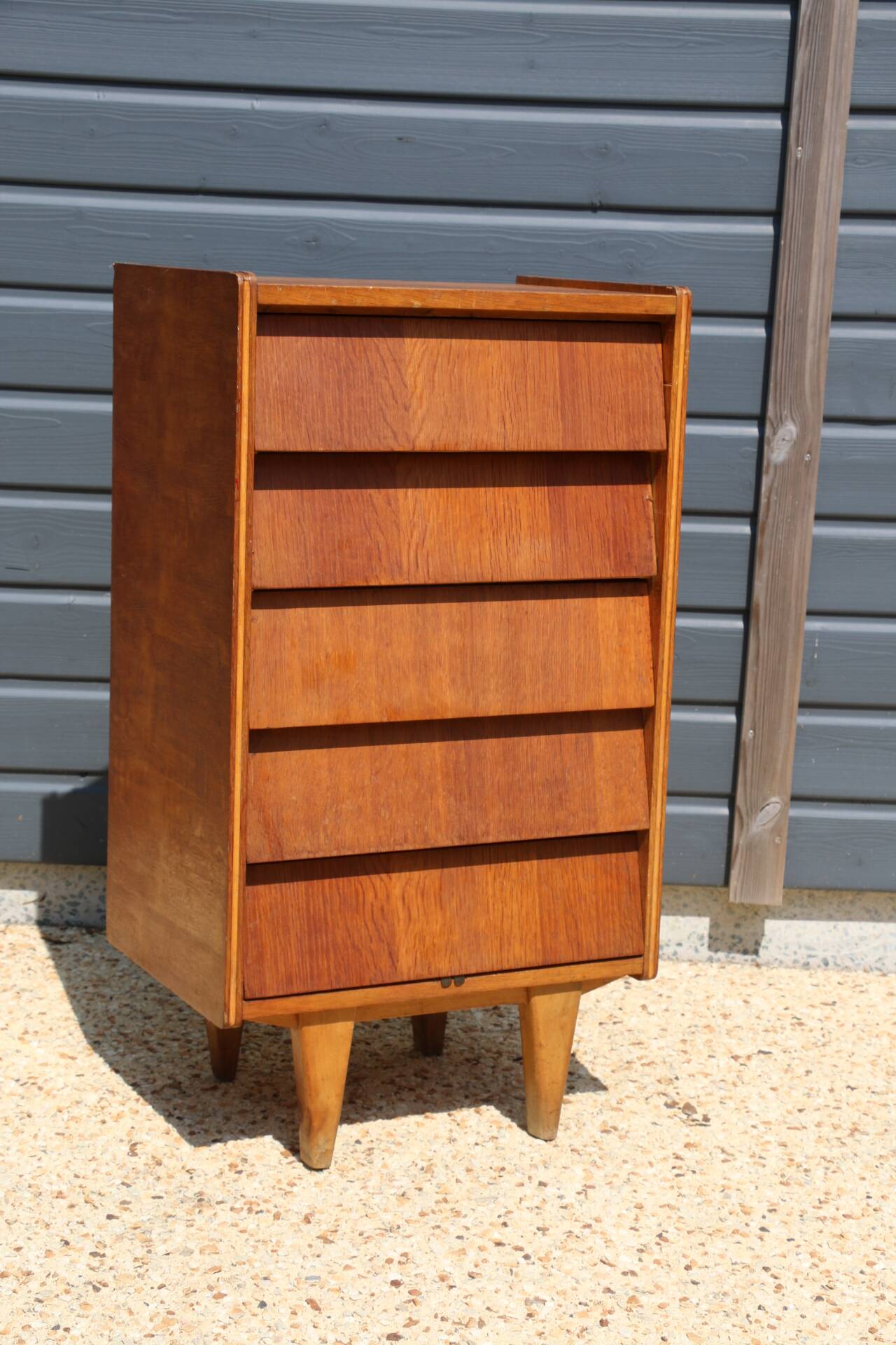 Dark chest of drawers with 5 drawers from the 1950s